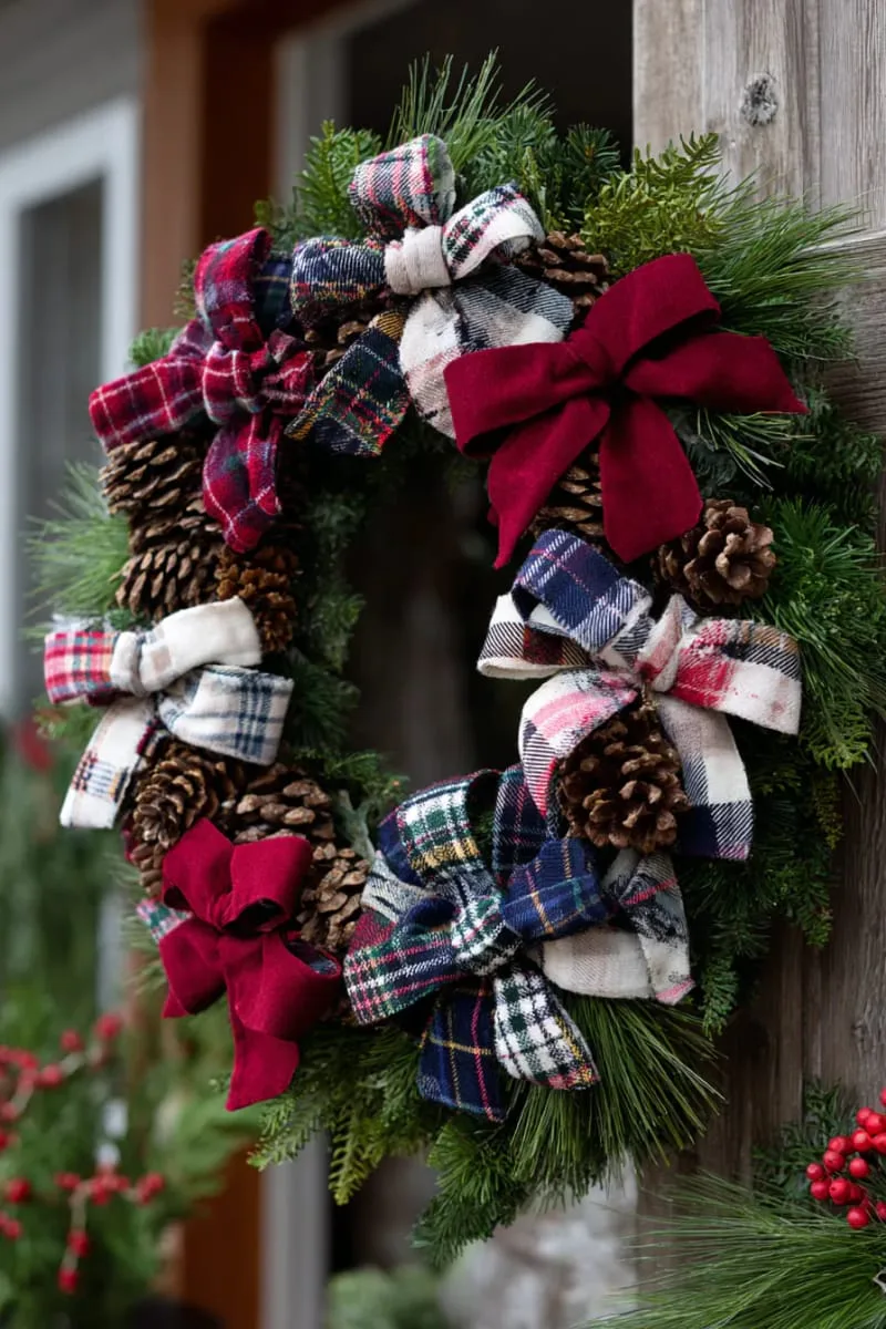 25 Upcycled Christmas Crafts DIY: Unique & Budget Friendly Decor Ideas 134 old flannel shirt christmas wreath with pinecones and plaid bows 1