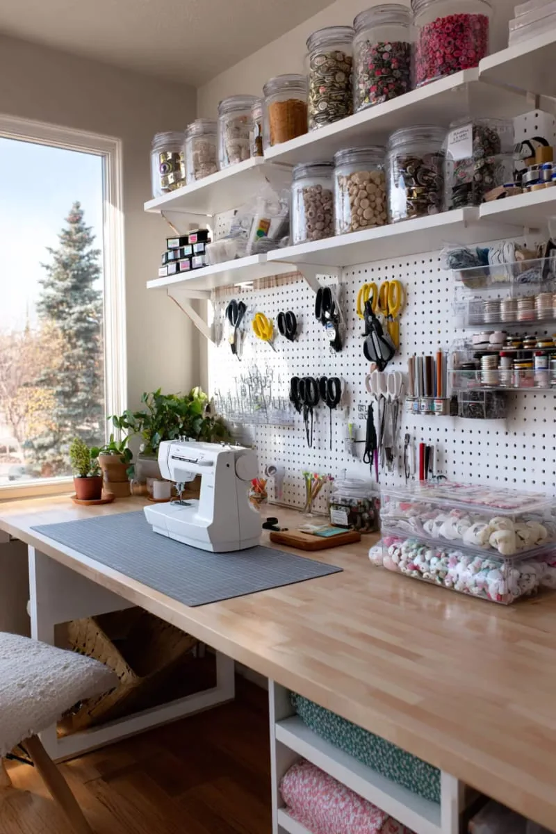 15 Sewing Room Organization Ideas to Declutter and Inspire Creativity 9 pegboard tool wall with labeled hooks for scissors, rulers, and rotary cutters 1