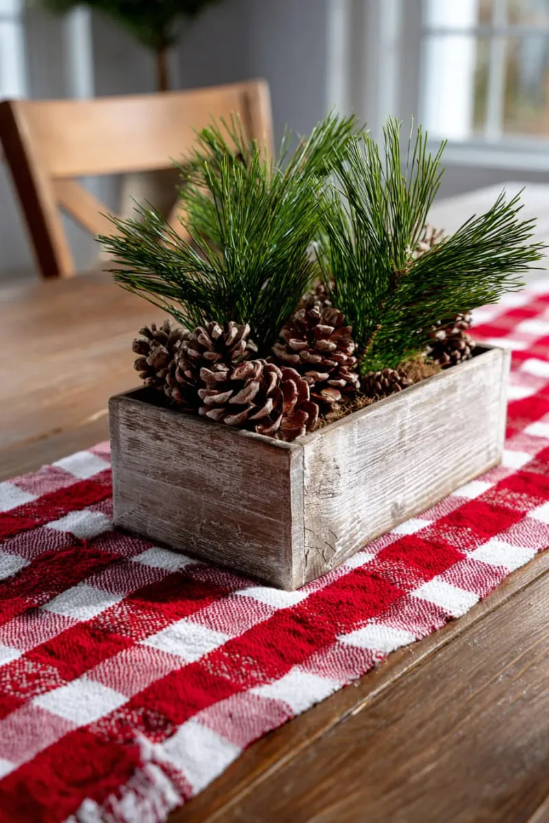 red and white checkered table runner with rustic centerpiece and pine sprigs 1
