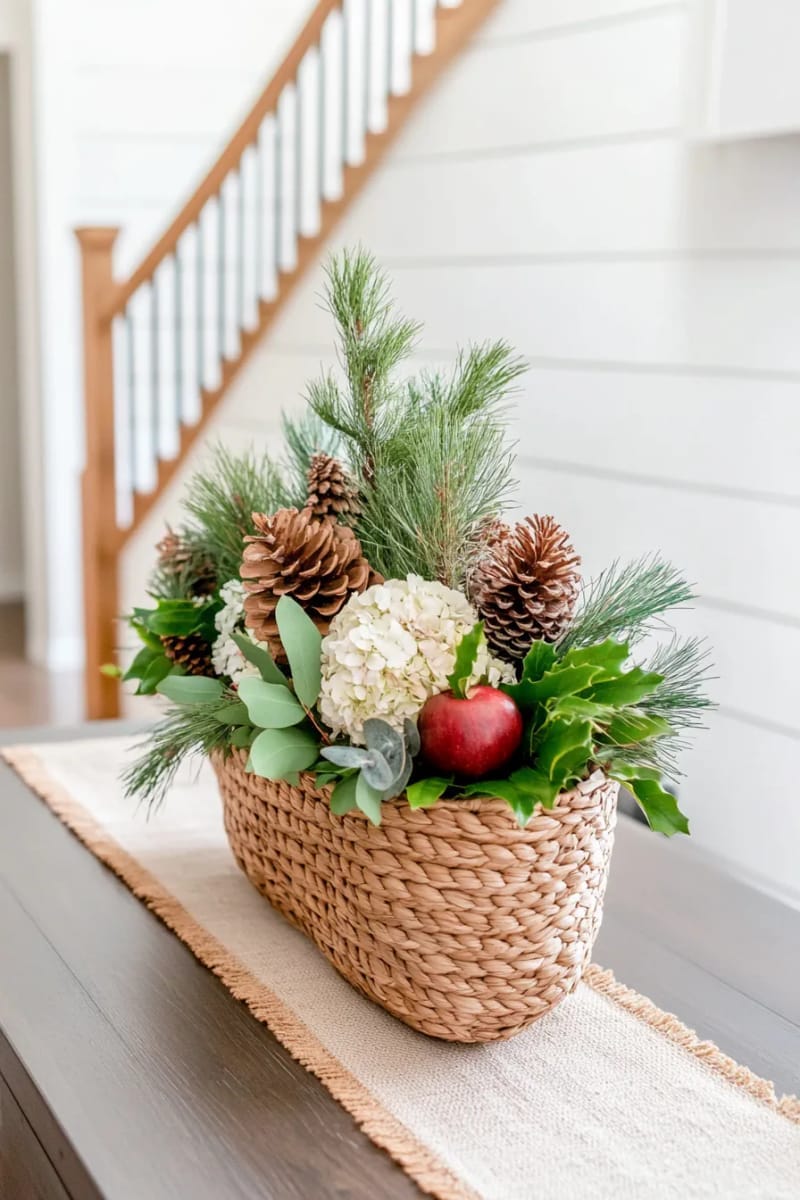 rustic basket filled with pine branches, dried hydrangeas, and apples 1