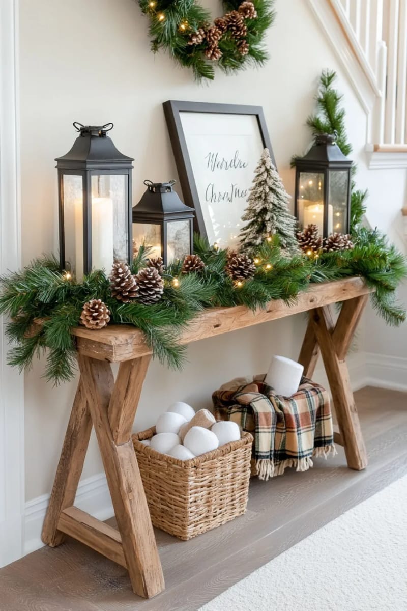 rustic entryway table styled with lanterns, greenery, and candle clusters 1