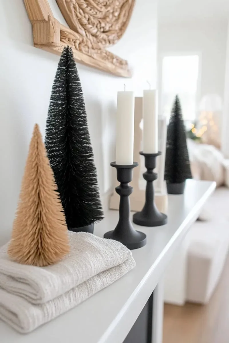 scandinavian black candle holders and geometric black trees on a mantel 1