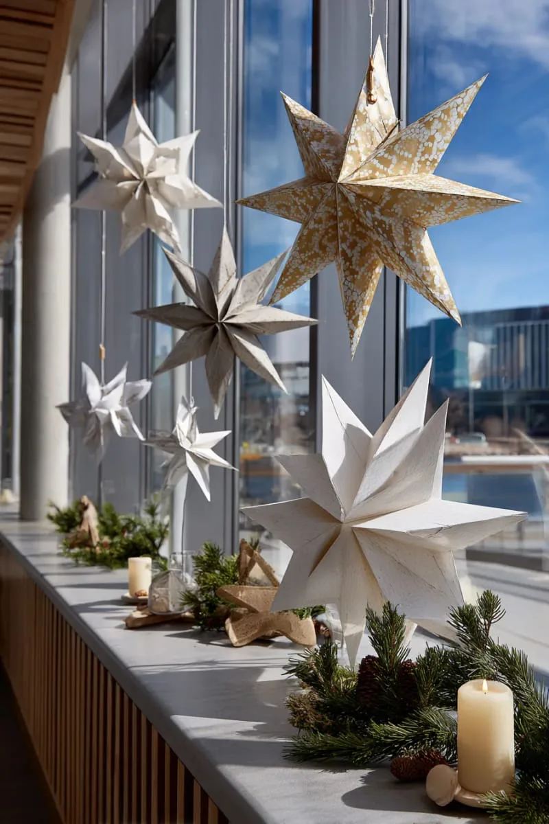 25 Best Christmas Window Decor Ideas to Try This Year 42 scandinavian-inspired paper stars hanging at various heights across the glass. 1