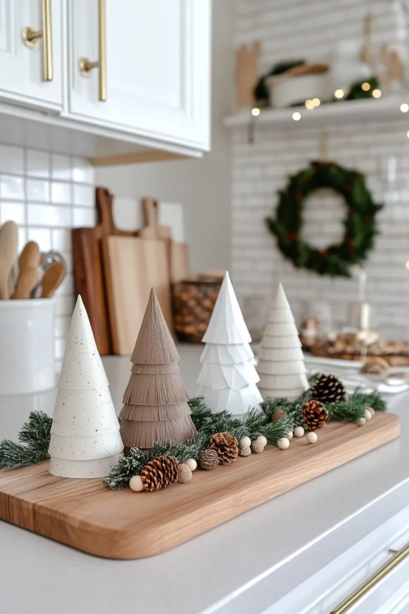 23 Christmas Countertop Decor Ideas Guests Can’t Stop Talking About 52 scandinavian-inspired paper trees and neutral wood beads 1