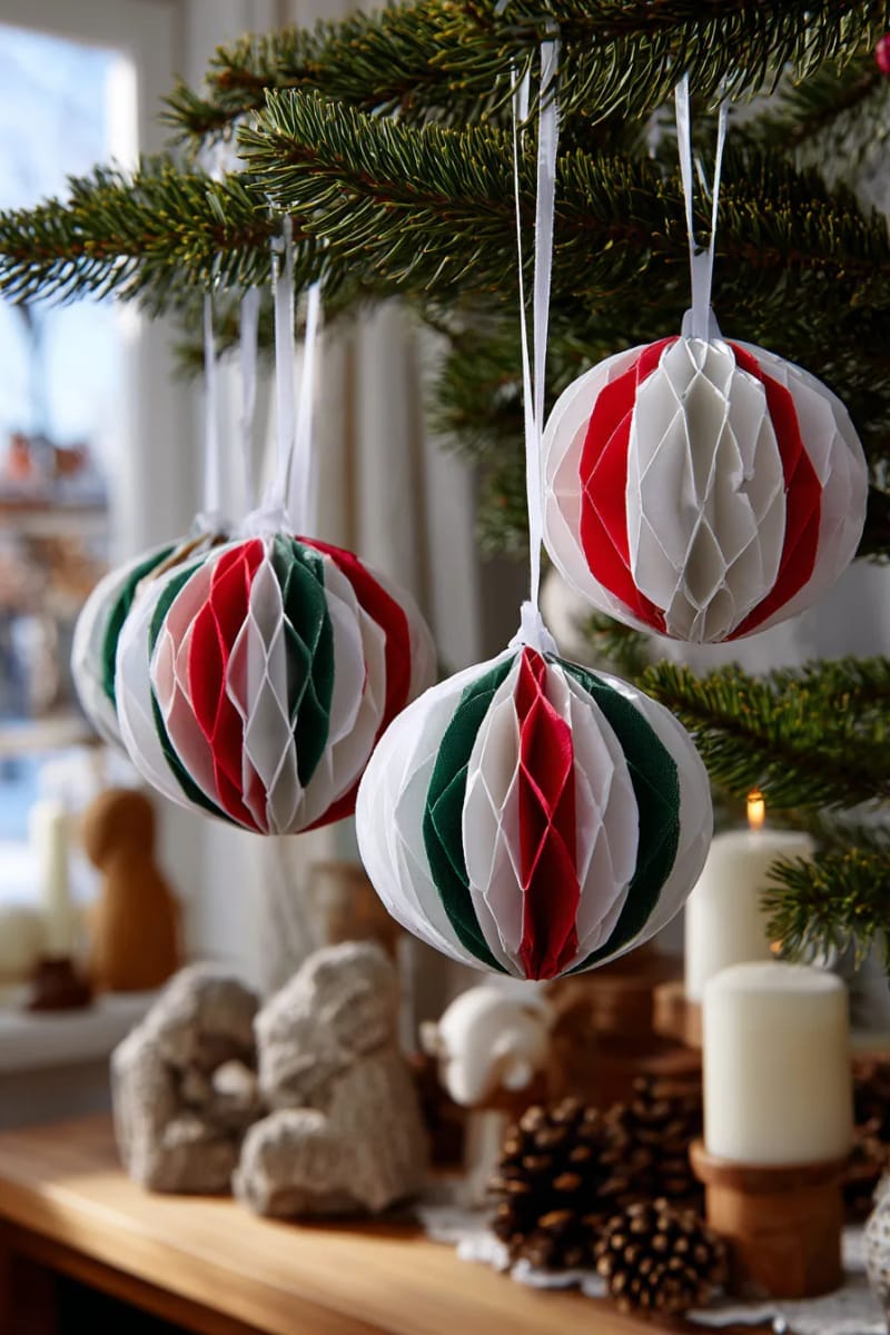 scandinavian-style paper ball ornaments with red, green, and white stripes 1