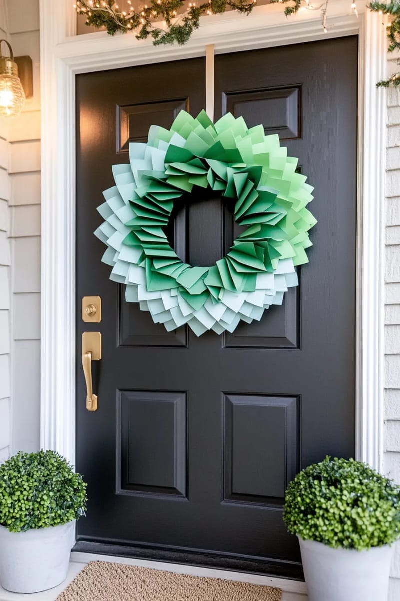 29 Festive Christmas Door Decor Ideas for a Magical Entry 26 sleek modern wreath made of folded paper christmas trees in ombre colors 1