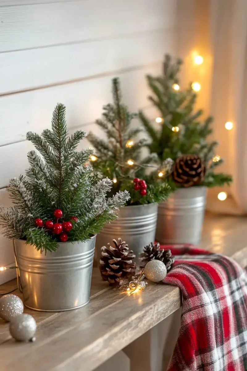 snow-dusted mini pine trees in galvanized metal buckets 1