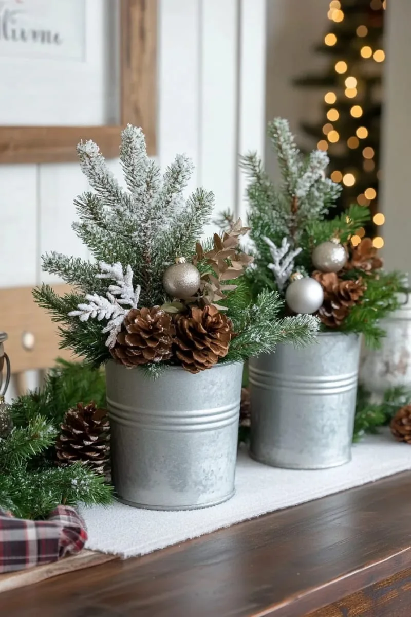 snow-dusted mini pine trees in galvanized metal buckets 1