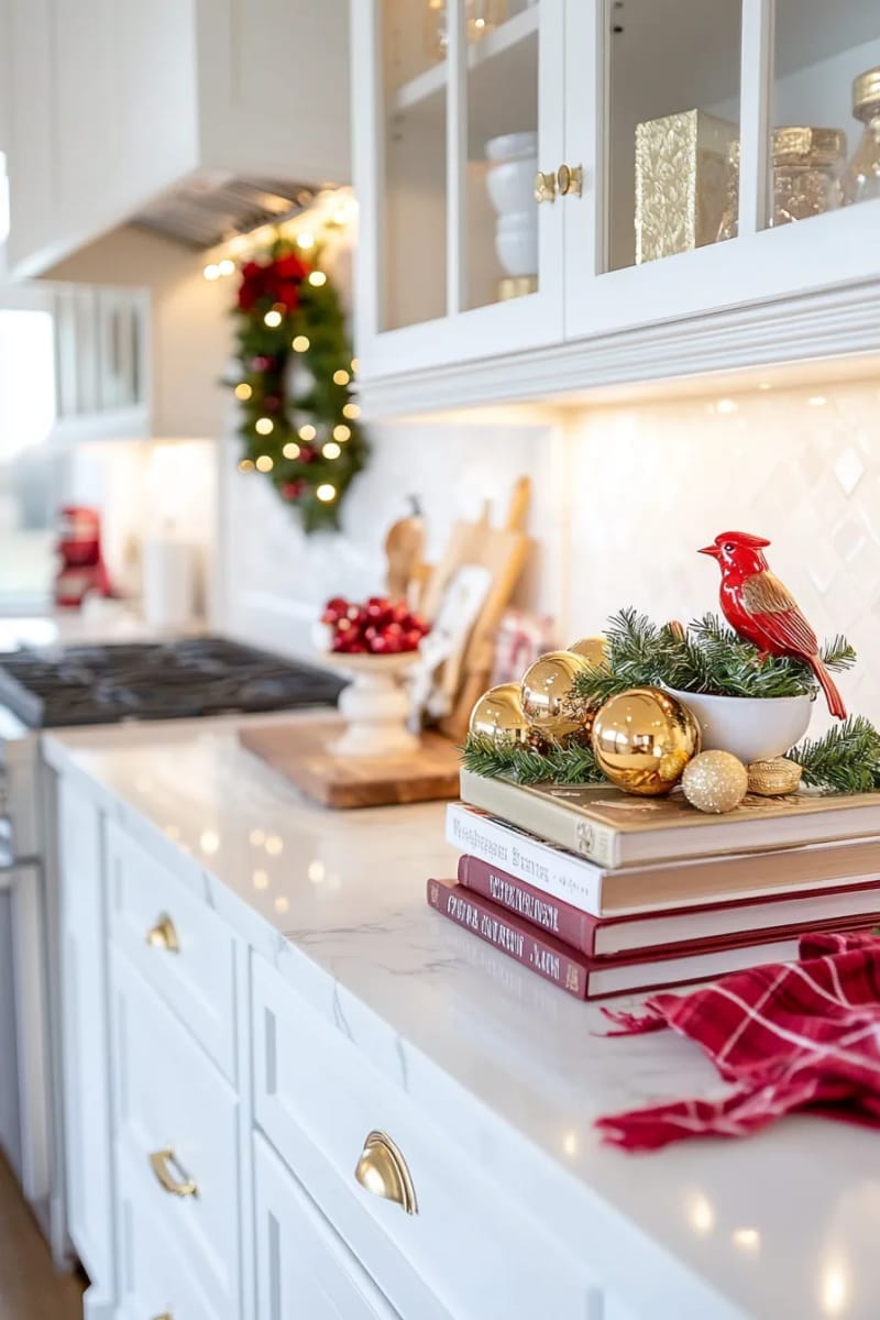 23 Christmas Countertop Decor Ideas Guests Can’t Stop Talking About 71 stack of decorative christmas books topped with a ceramic cardinal 1