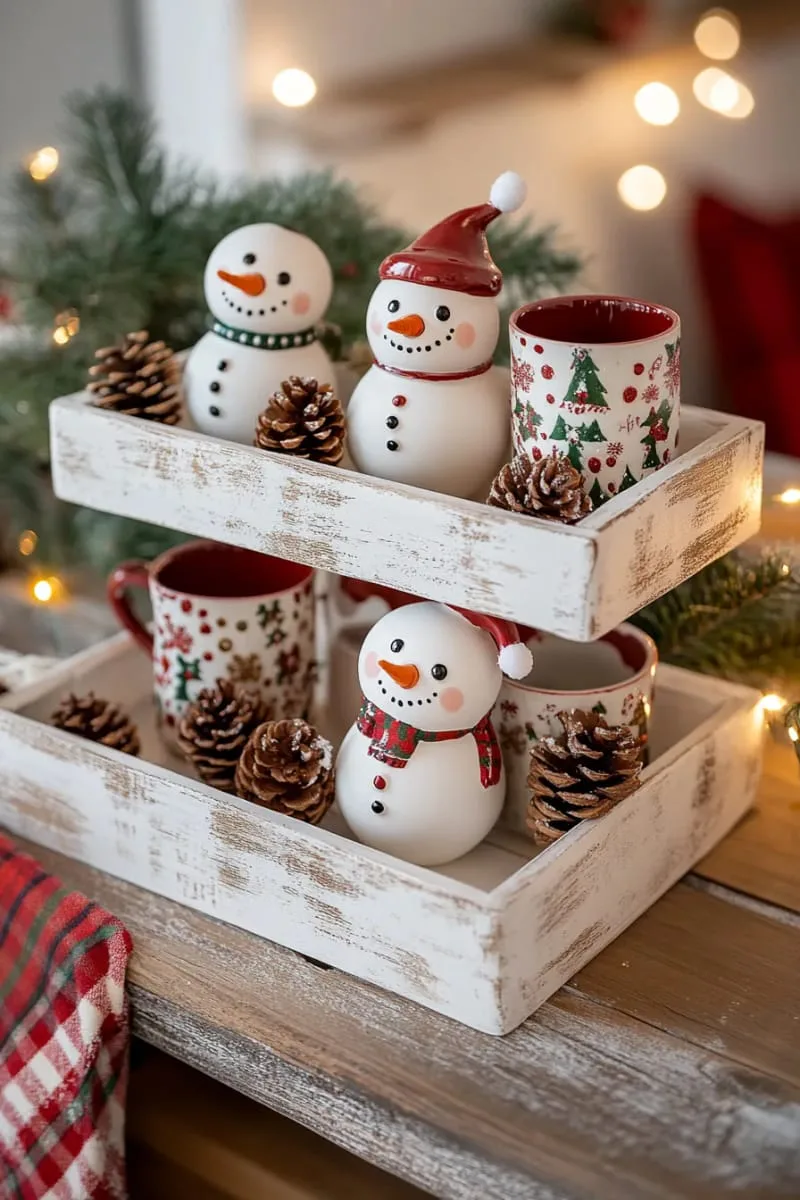 29 Best Christmas Decorations Trends You Can't Miss This Year 134 tiered tray with tiny snowmen, pinecones, and festive mugs 1