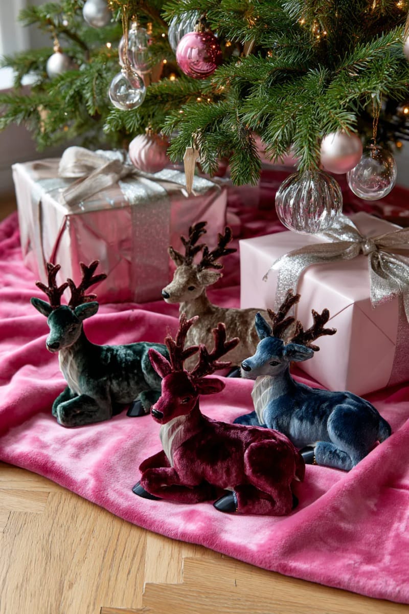 23 Kitsch Christmas Decor Ideas Full of Color, Whimsy, and Cheer 19 velvet reindeer figurines arranged under a neon pink tree skirt 1