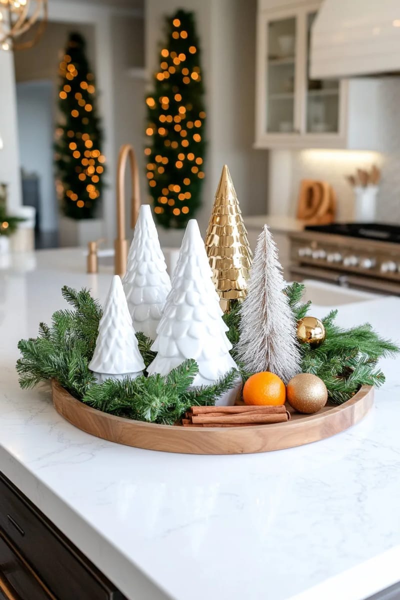 23 Christmas Kitchen Island Decor Ideas That Bring Instant Holiday Charm 9 white ceramic trees with metallic ornaments on a round wooden tray 1