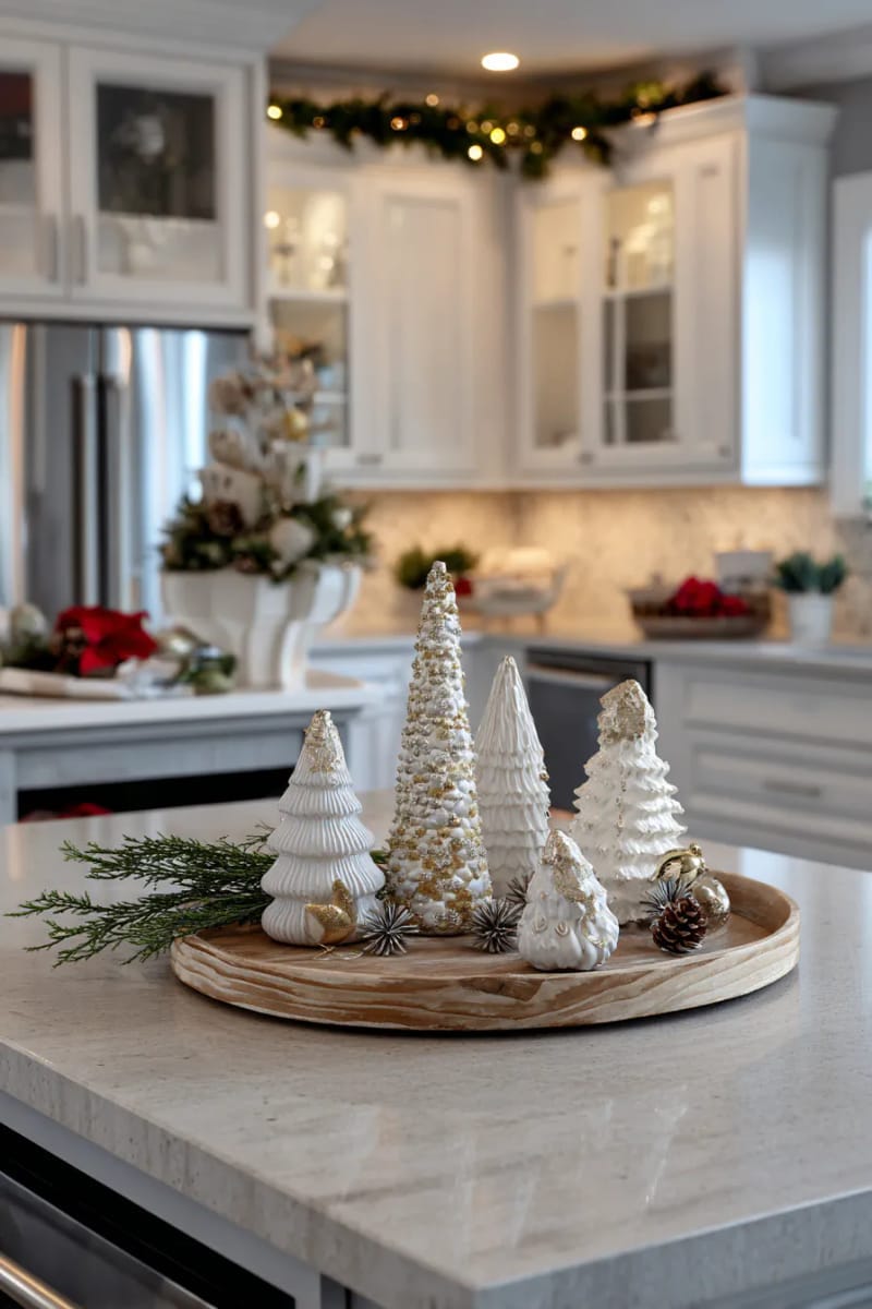 23 Christmas Kitchen Island Decor Ideas That Bring Instant Holiday Charm 10 white ceramic trees with metallic ornaments on a round wooden tray 1