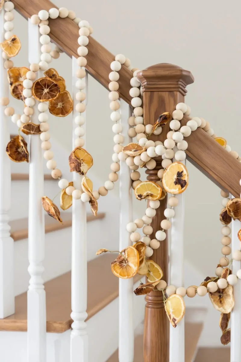 wooden bead and dried fruit garland along the staircase railing 1