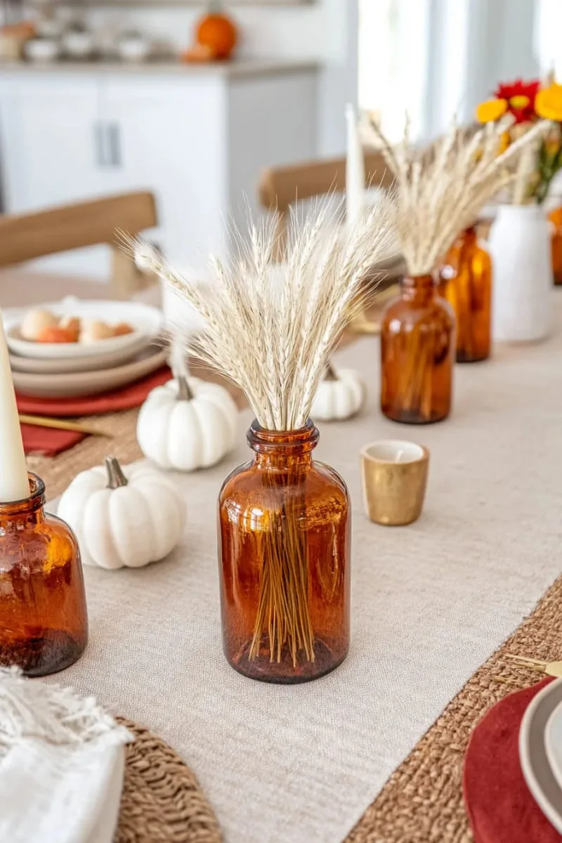 amber glass bottles filled with dried wheat and pampas grass 1