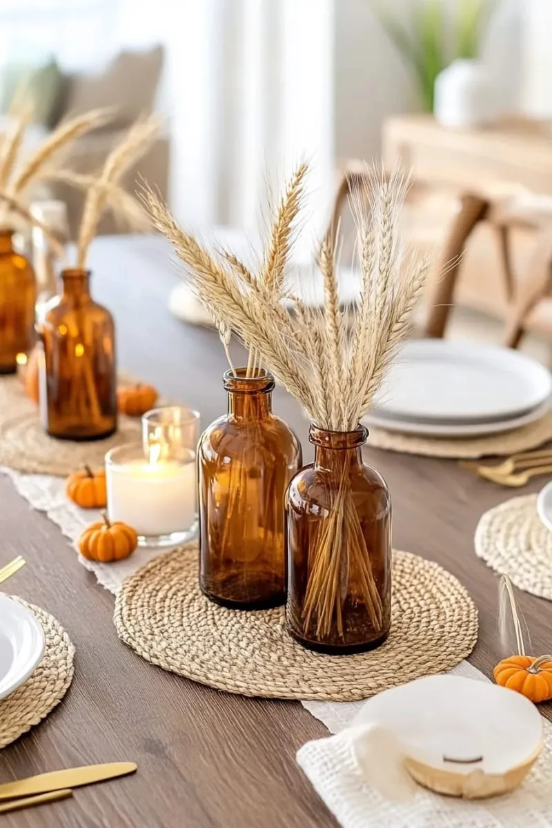 amber glass bottles filled with dried wheat and pampas grass 1