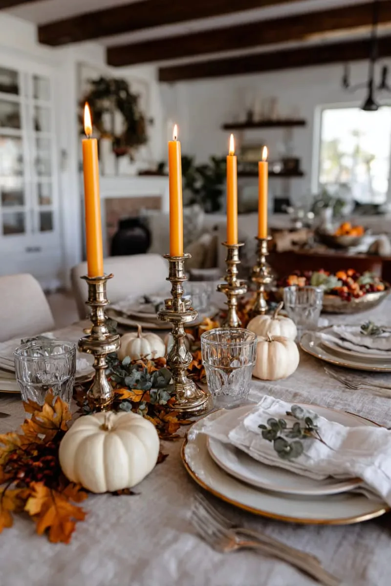 antique brass candlesticks paired with orange taper candles 1