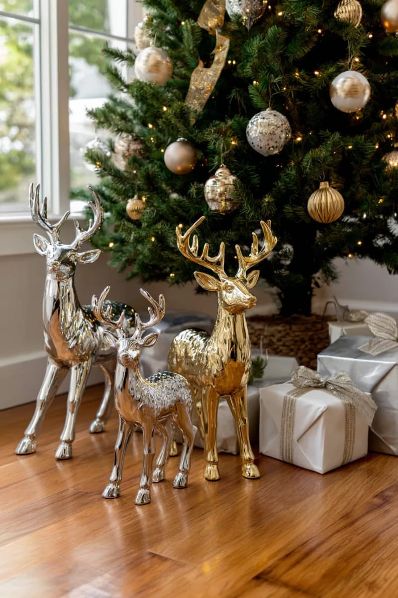 arrange a trio of metallic deer statues beneath a classic christmas tree. 1