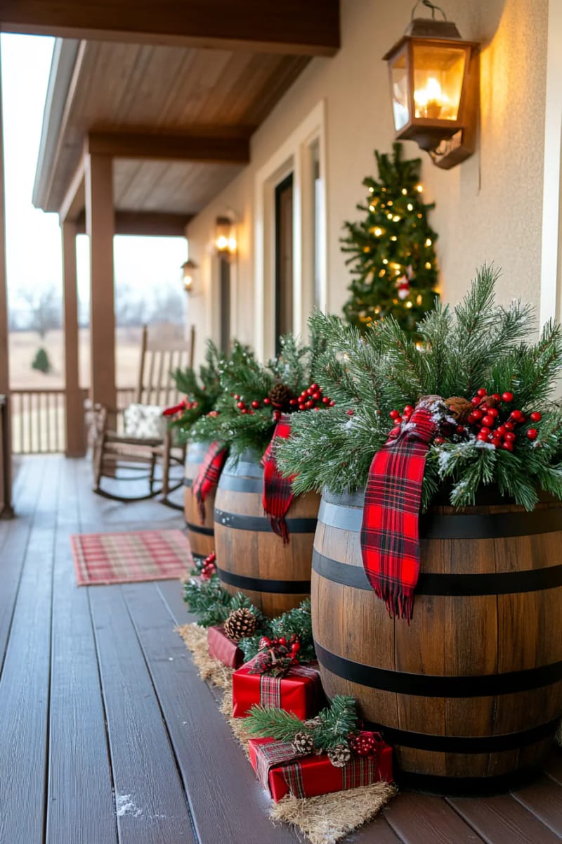 barrel planters overflowing with pine branches, red berries, and plaid ribbon bows 1