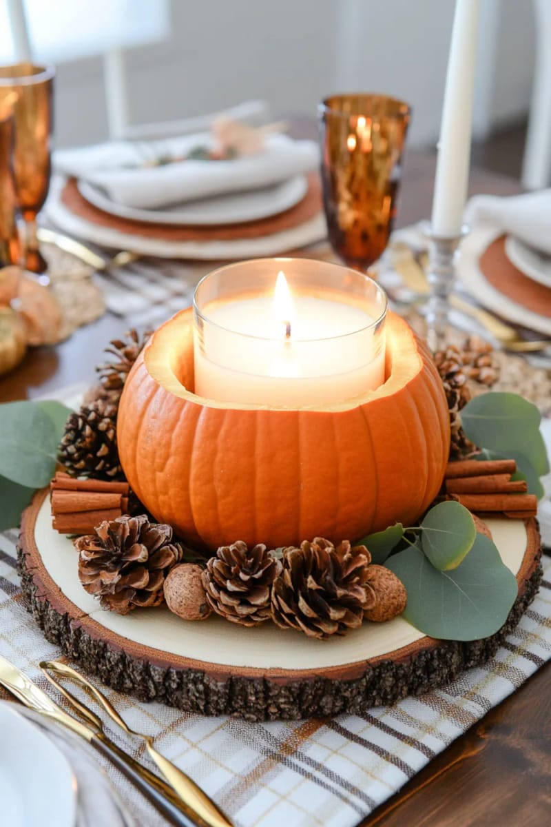 candlelit pumpkin centerpiece with pinecones and cinnamon sticks 1