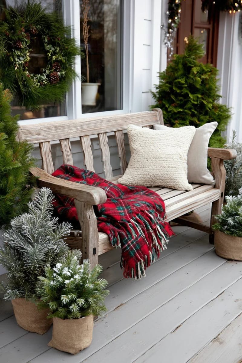 cozy plaid blanket draped on a vintage bench with mini trees 1