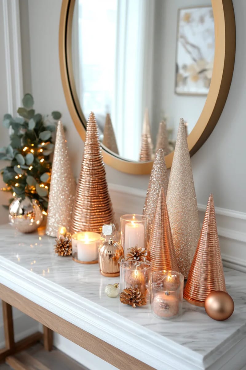display shimmering copper and rose gold cone trees on a marble entryway table. 1