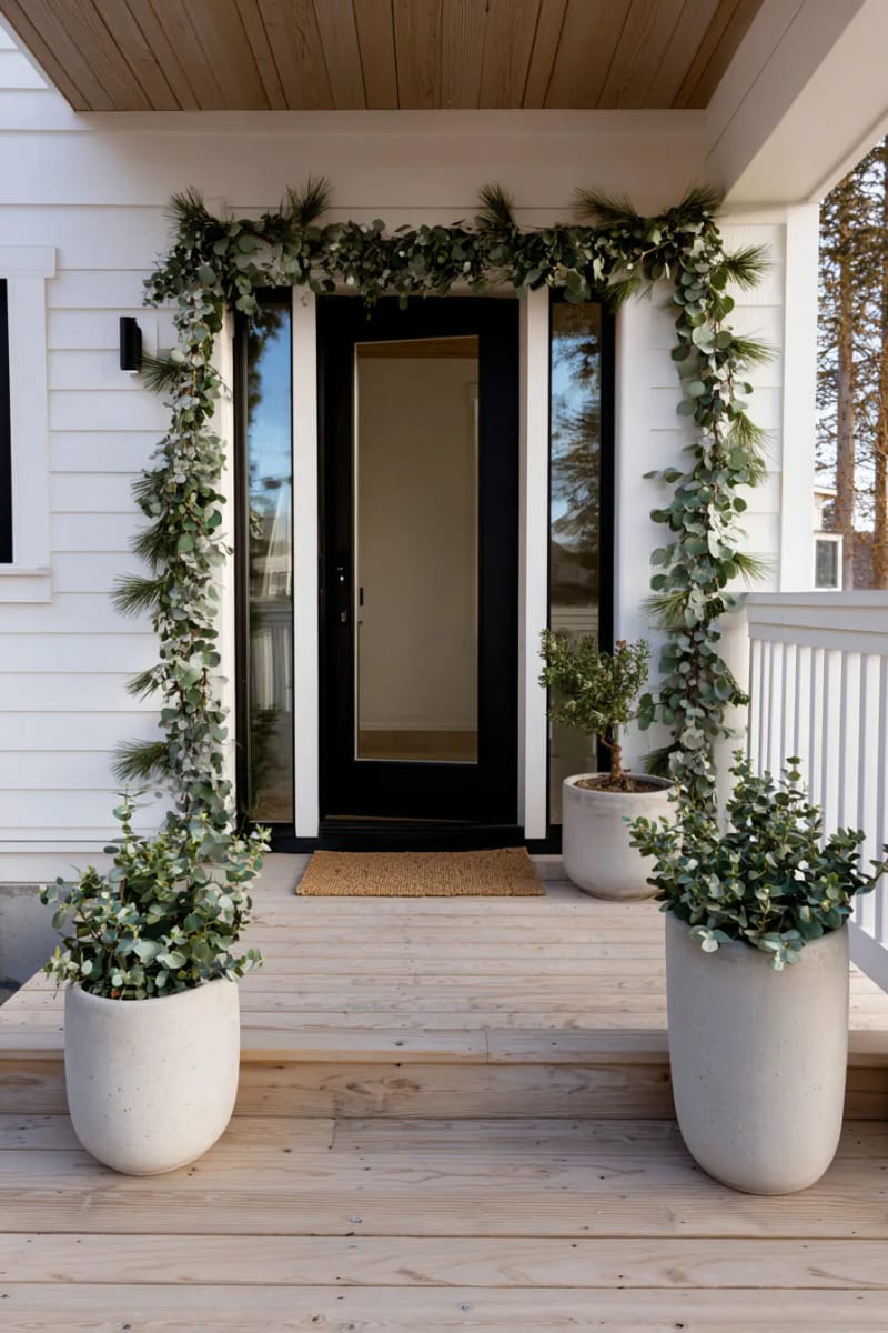 minimal garland with eucalyptus draped around the door frame 1