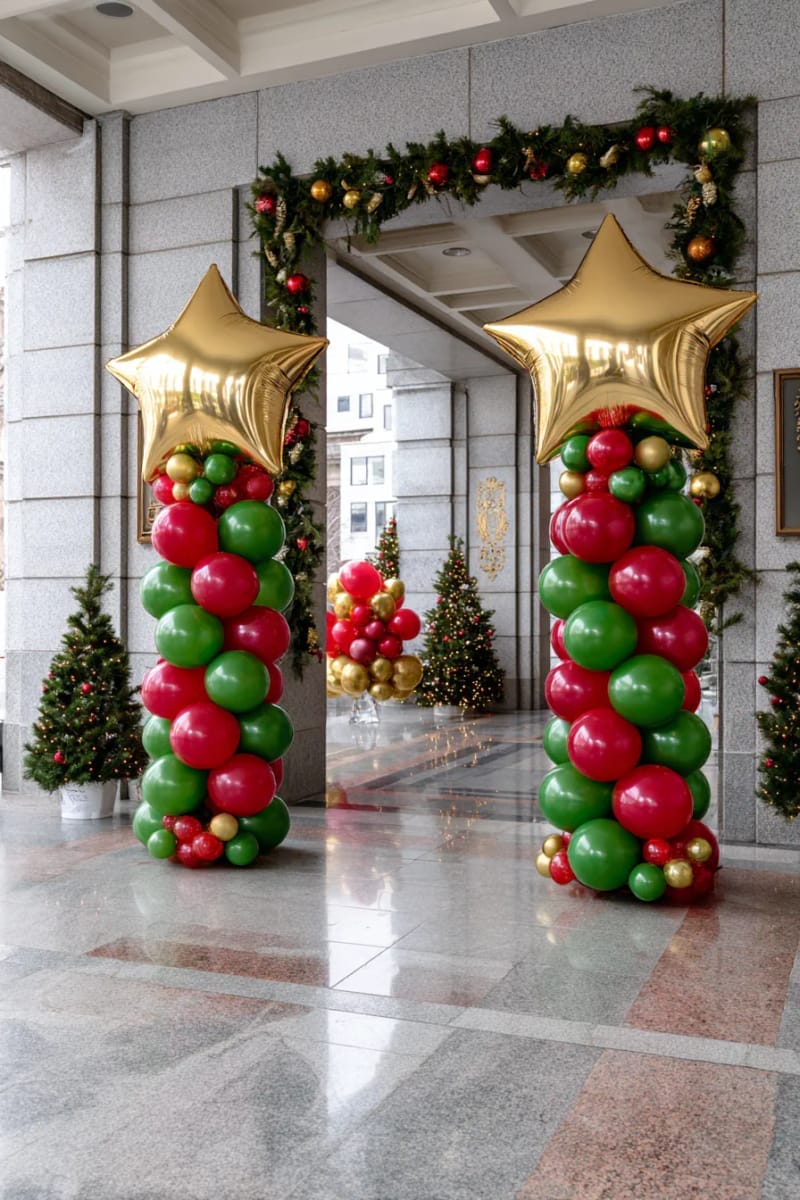 red and green balloon columns topped with golden stars at party entrance 1