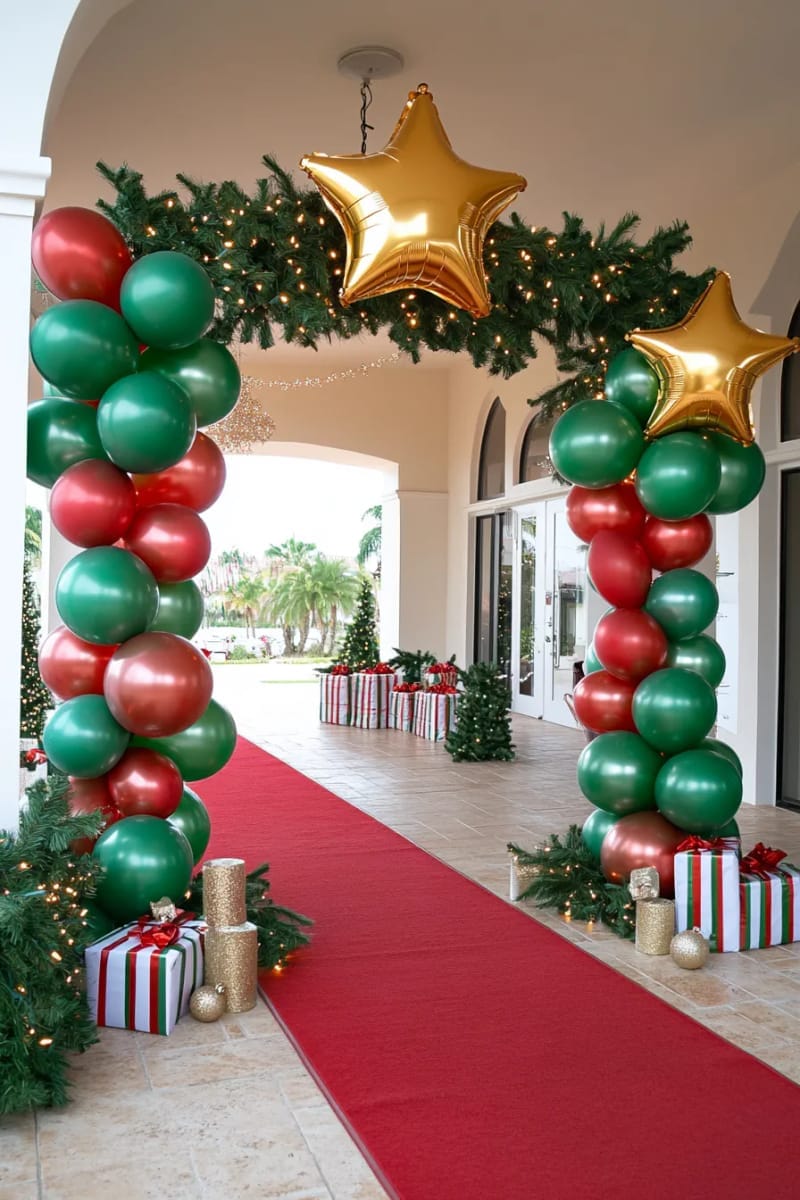 red and green balloon columns topped with golden stars at party entrance 1