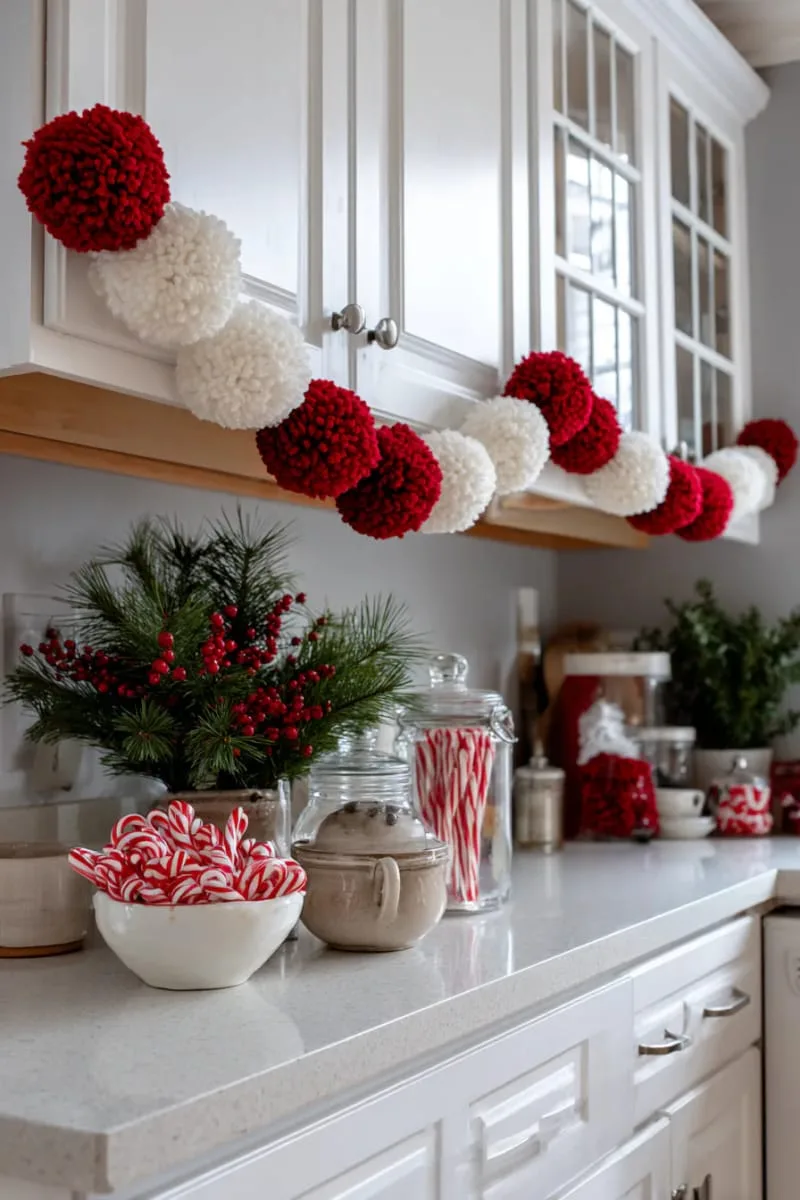 red and white pom-pom garland strung across cabinet doors 1