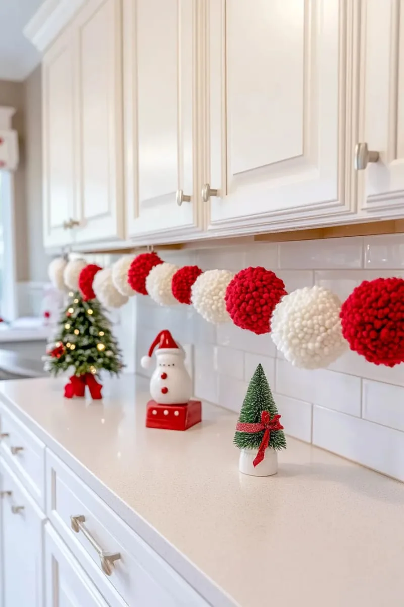 red and white pom-pom garland strung across cabinet doors 1