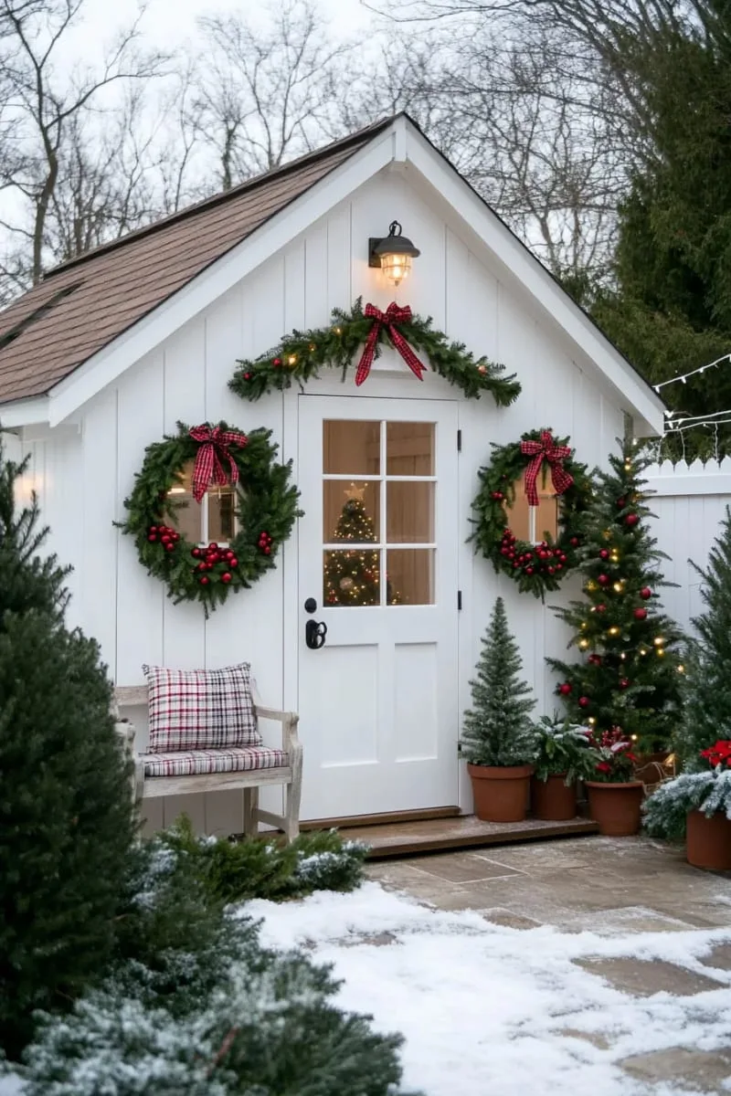 15 She Shed Christmas Decor Ideas For A Unique Winter Wonderland 27 red ribbon bows and cranberry string garlands along the roof edge 1