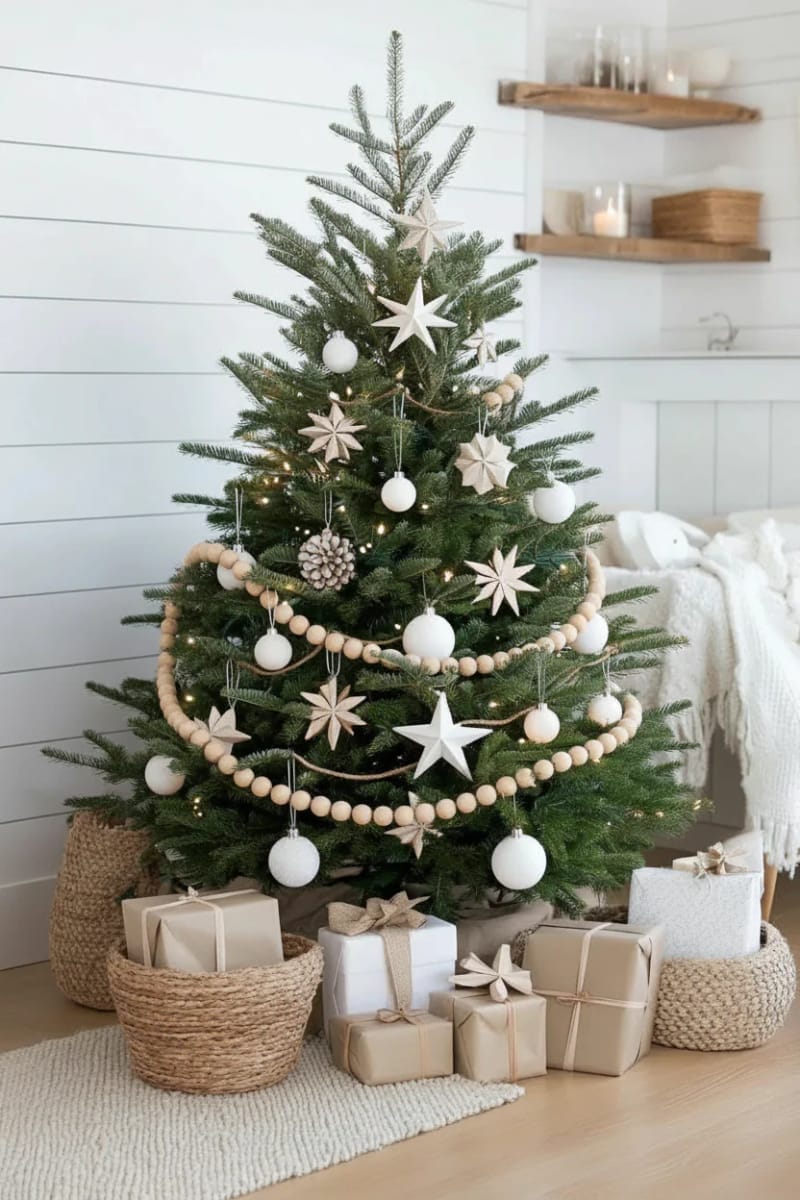 scandinavian style tree with white ornaments, paper stars, and natural wood garland 1