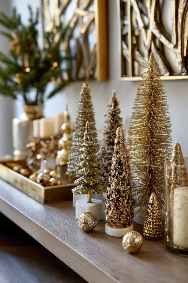 set up a collection of bronze and gold bottlebrush trees on a sideboard. 1