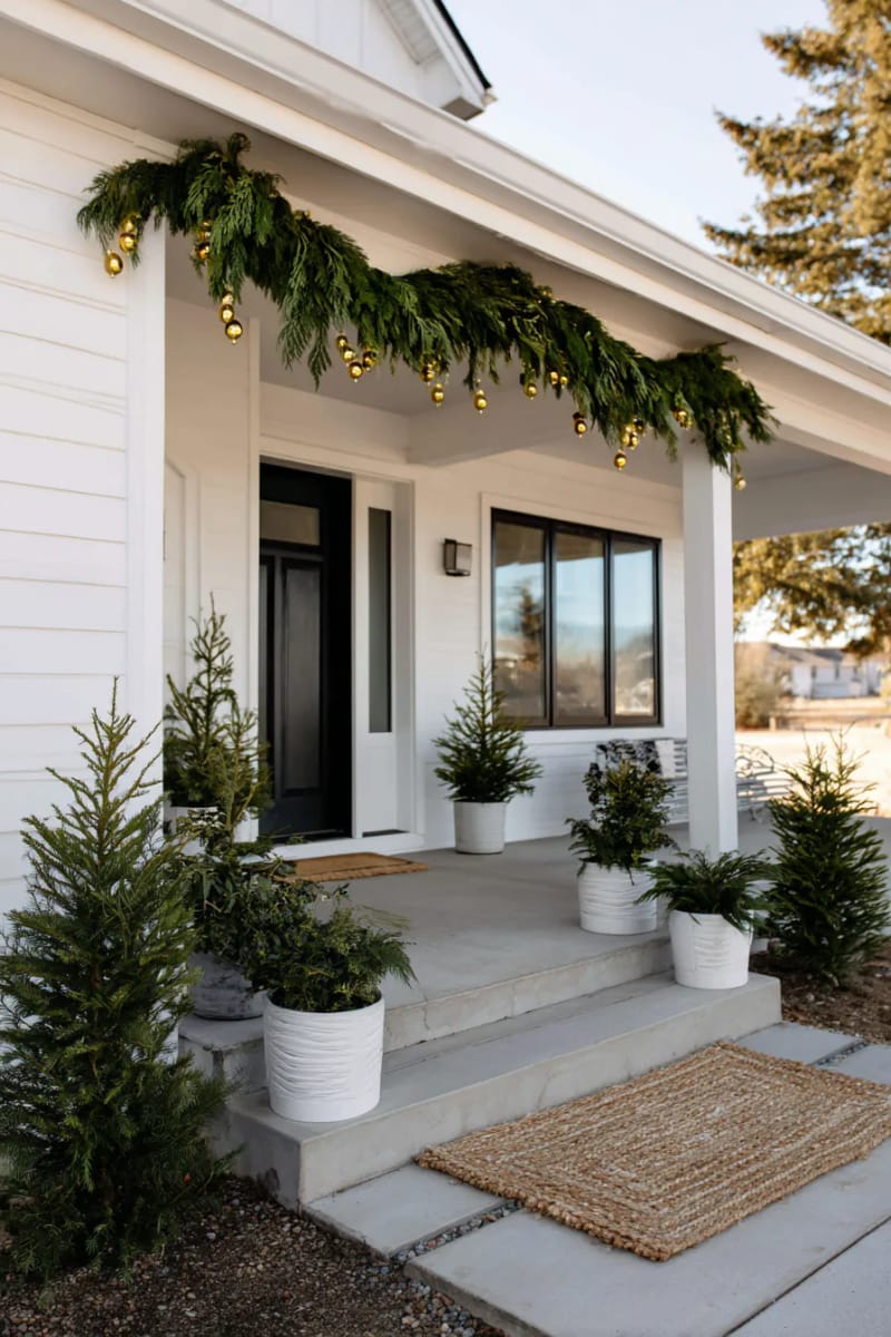 sparse greenery garland with tiny gold bells above the door 1