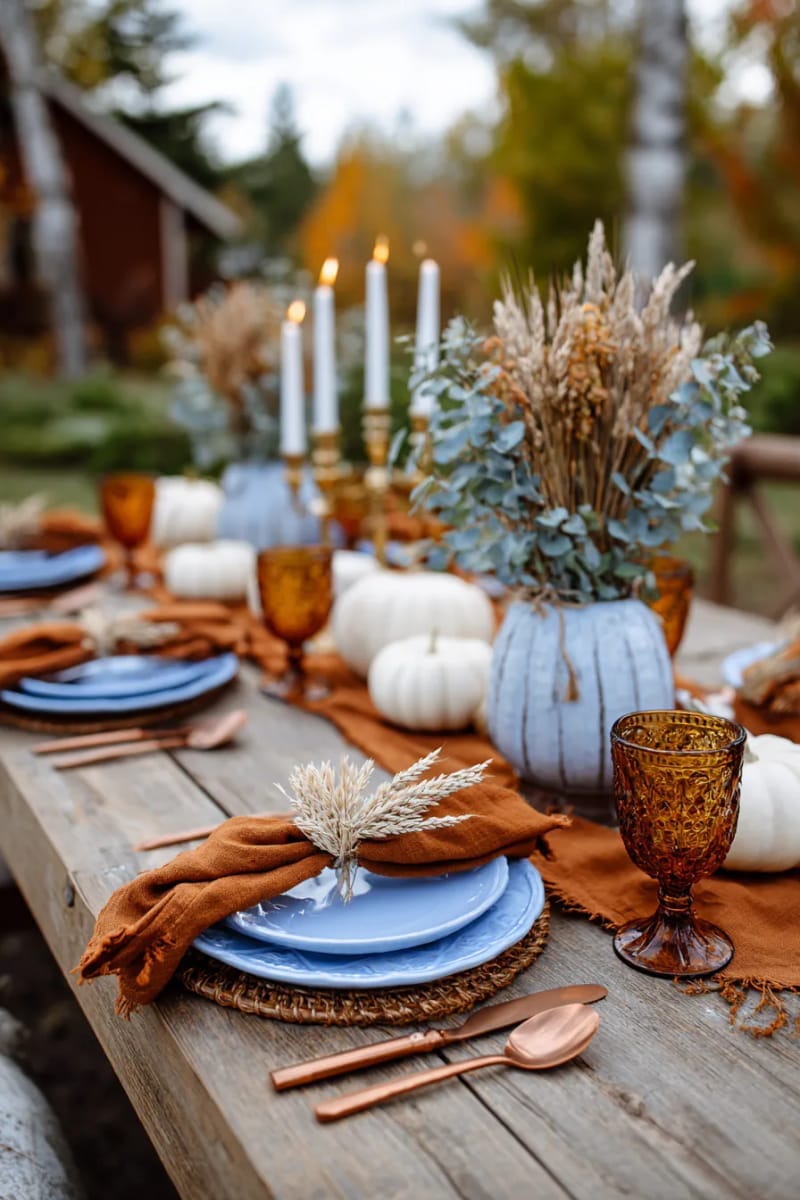 vintage blue plates mixed with copper flatware and burnt orange linens 1