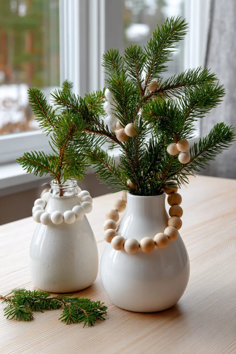 21 Scandinavian Christmas Decorations Ideas To Bring Nordic Charm at Home 5 wooden bead garlands draped over pine branches in simple scandinavian vases 1