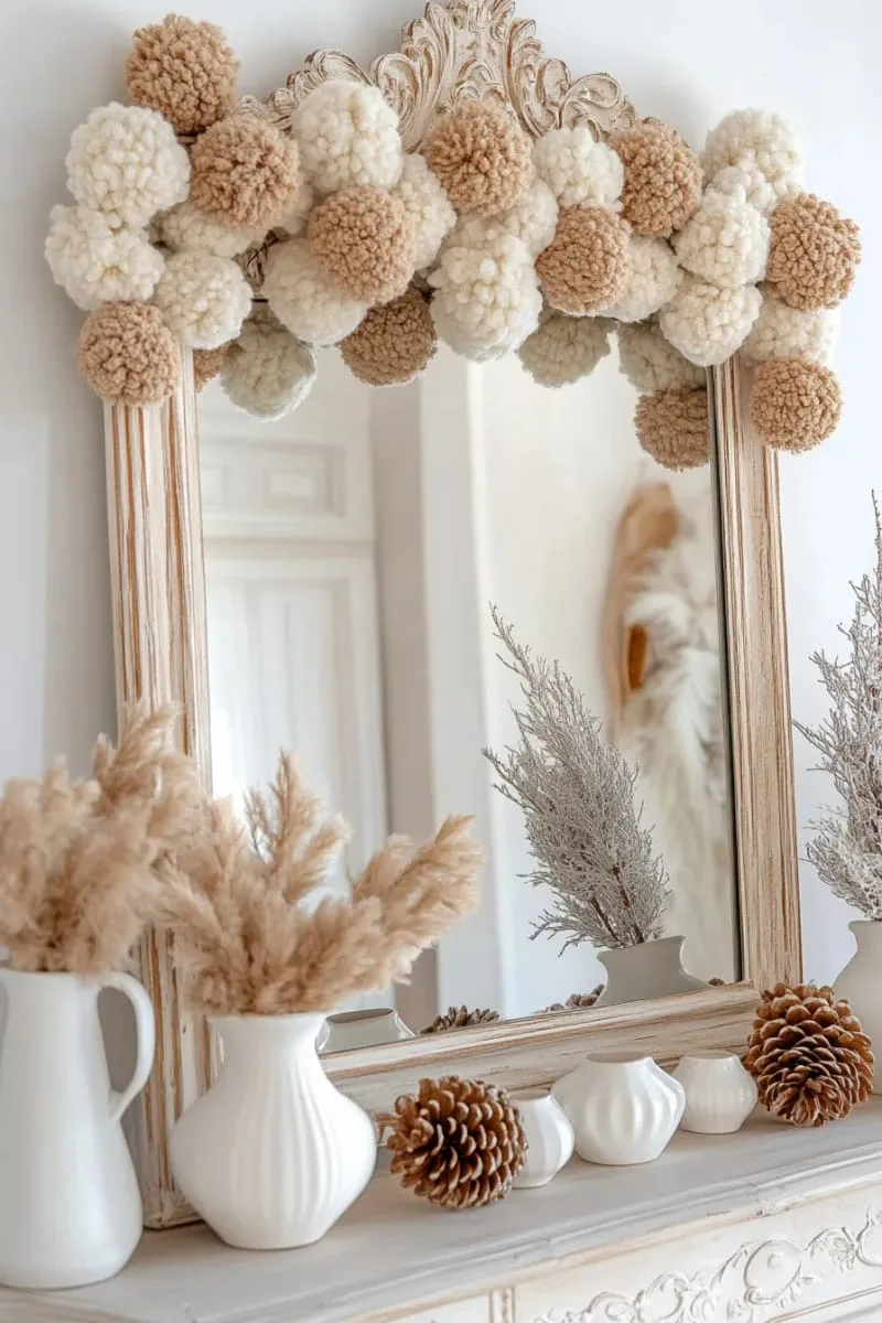 neutral pom-pom garland draped across a vintage mirror 1