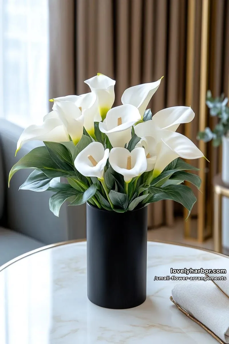 19 Classy Small Flower Arrangements to Cheer You Up in Spring 30 modern calla lilies and greenery in a black cylinder vase 1