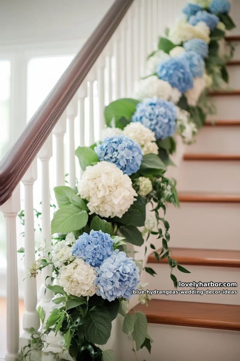 blue and ivory hydrangea garland wrapped around staircase railing 1