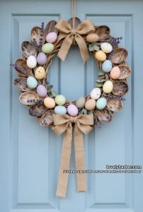 farmhouse style wreath using old wooden spoons, twine, and speckled eggs 14