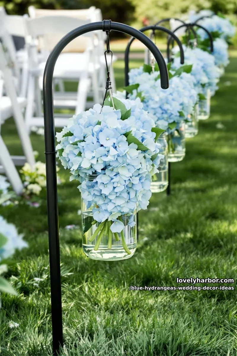 glass jars of baby blue hydrangeas hanging from shepherd’s hooks 1