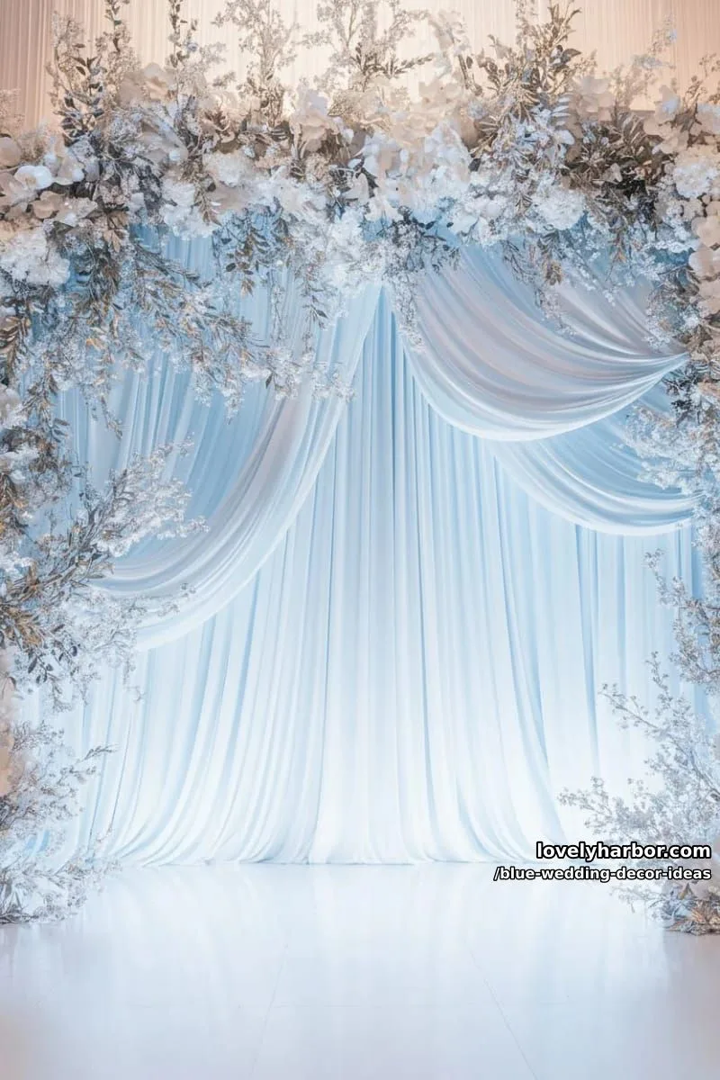 pale blue drapery backdrops adorned with silver floral garlands 1