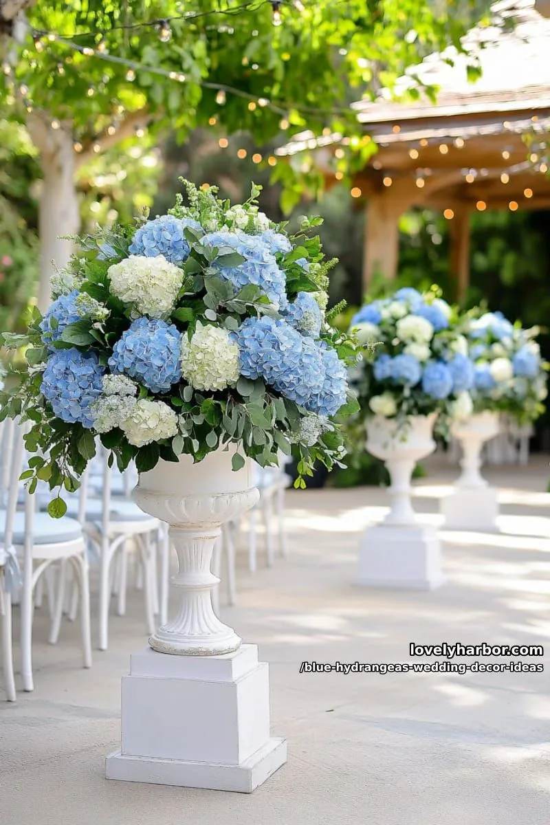 round topiary balls of blue hydrangeas on white pedestals 1