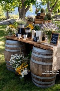 rustic barrels stacked as a coffee station with wildflower arrangements 5