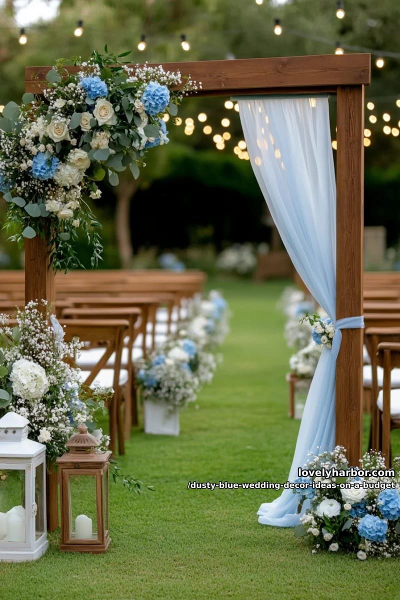 sheer dusty blue fabric draped across rustic wooden archways outdoors 1