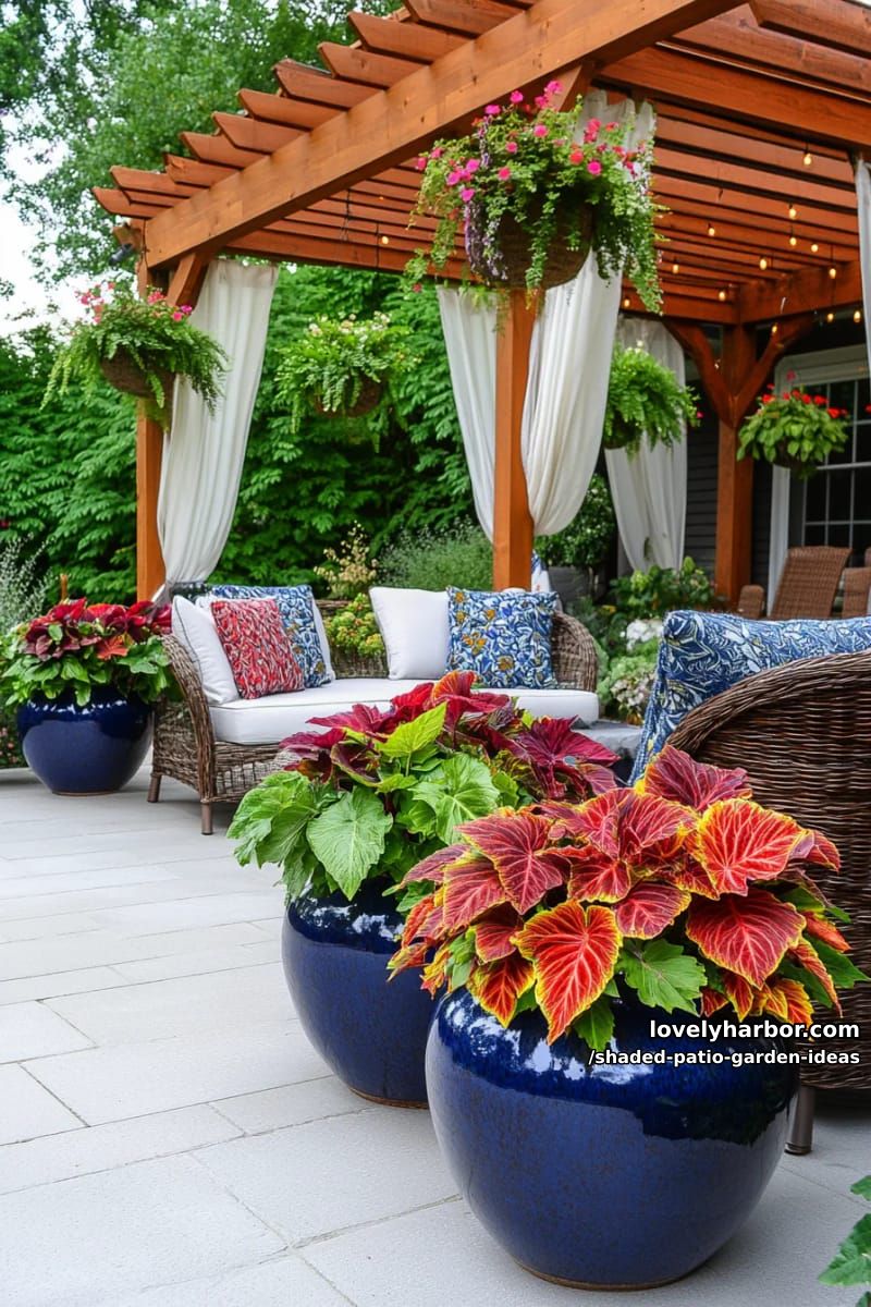 large ceramic planters overflowing with coleus, begonias, and caladiums 1