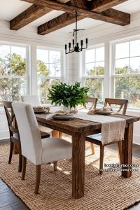 modern farmhouse dining with exposed beams, mixed chairs, beige runner, leafy centerpiece, iron chandelier. 47