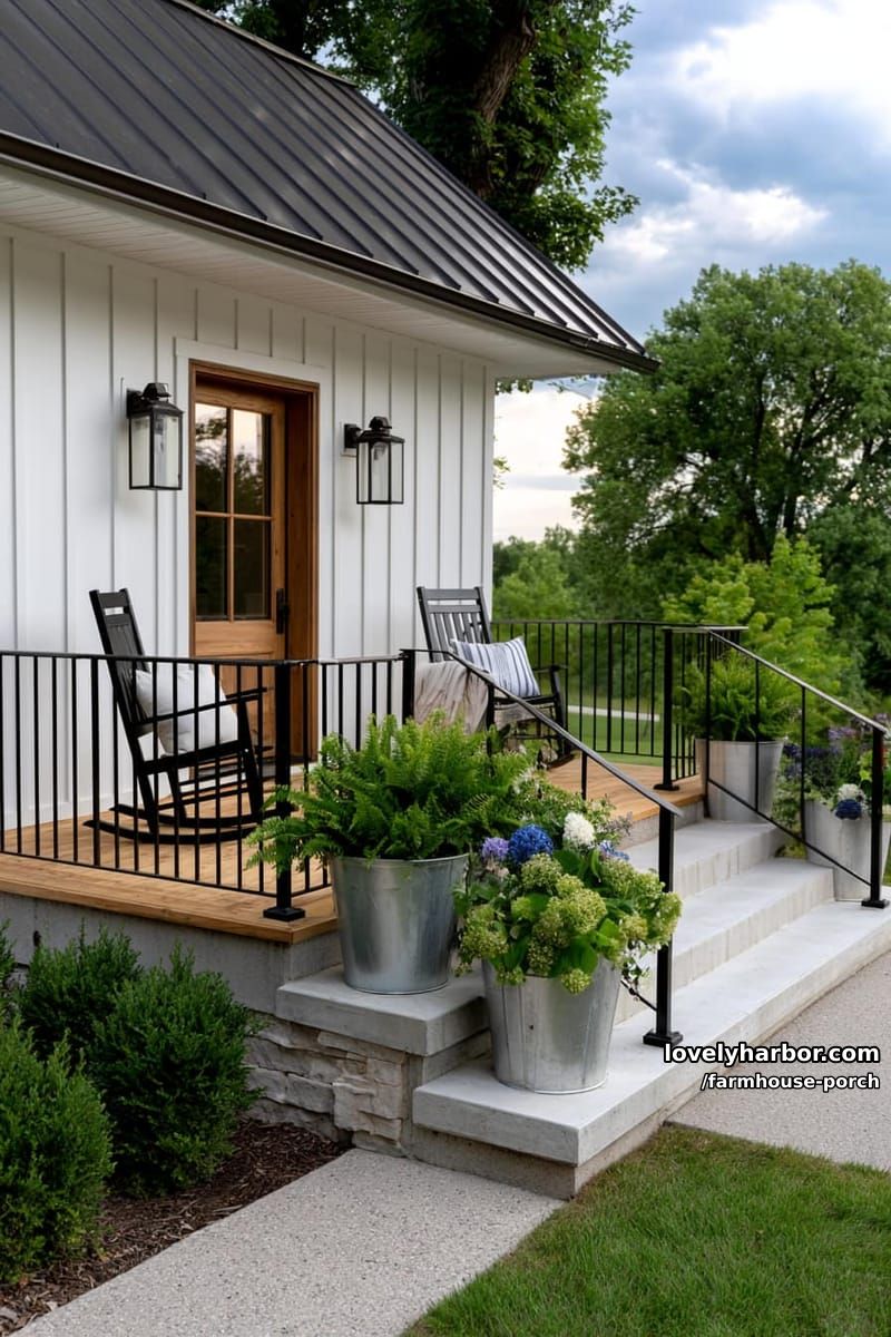 modern farmhouse porch with black rocking chairs, lantern lights, and metal planters. 1