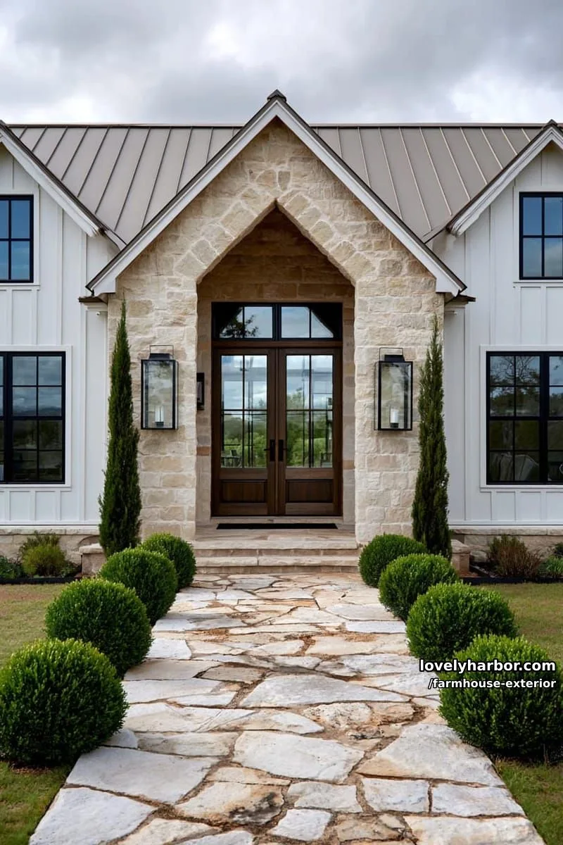 44 New Farmhouse Exterior Designs To Copy 46 modern farmhouse, stone entry, white siding, metal roof, flagstone path, boxwood shrubs. 1